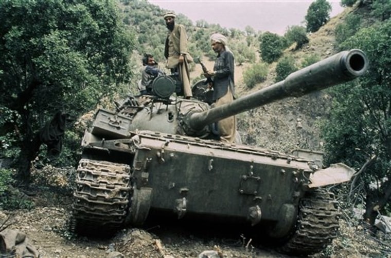 Mujahedeen guerrillas sit atop a captured Russian T-55 tank in 1987. The U.S.-led coalition has now been fighting in Afghanistan for as long as the Soviets did.